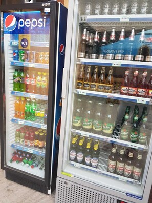 Two beverage vending machines with various drinks including Pepsi, Heineken, and other brands. - Casa Stefan Galati (Galati)