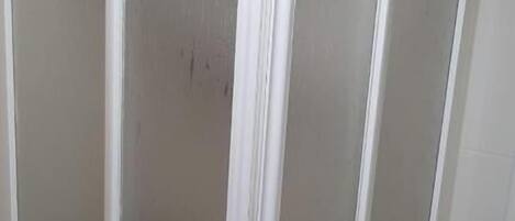 A white sliding door with a frosted glass panel.
