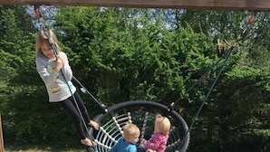 A swing set with two children and an adult. - Bygholm Camping Thy (Vesløs)