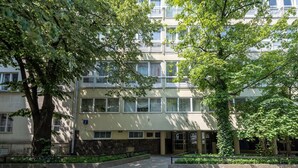 A multi-story building with a flat facade, large windows, and a central entrance. - Friends Avenue Apartment (Warsaw)