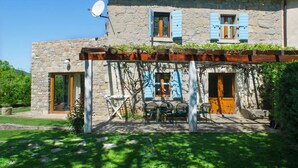 A stone house with blue shutters, a pergola with outdoor seating, and a satellite dish. - Charming 2BR Villa with pool for 4+1, for small groups, pet-friendly (Buzet)