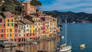A waterfront with colorful buildings, a sailboat, and a small rowboat. - Villa Perla by VILLASRETREATS w/Pool, A/C, WiFi, BBQ near 5 Terre (Pignone (La Spezia))