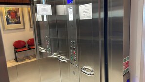 A modern elevator with digital displays, clear signage for floor numbers, and a metal handle. - Penta Hotel (Douglas)