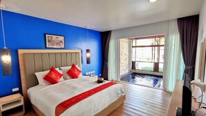 A hotel room with a large bed, a small bedside table, a TV, and a window with a view of a swimming pool. - Apartment with private jacuzzi and pool access. Just 800 meters to the beach. (Phuket)