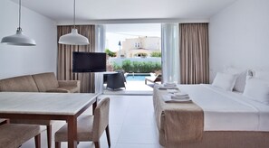 A hotel room with a bed, a TV, a dining area, and a view of a pool and buildings. - Private Pool | 800m from the Beach (Albufeira)