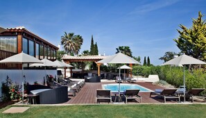 A poolside area with lounge chairs, umbrellas, and a pool. - Private Pool | 800m from the Beach (Albufeira)