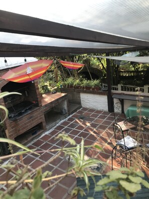 Enjoy al fresco dining and relaxation in this outdoor patio area with a barbecue grill and seating for two.