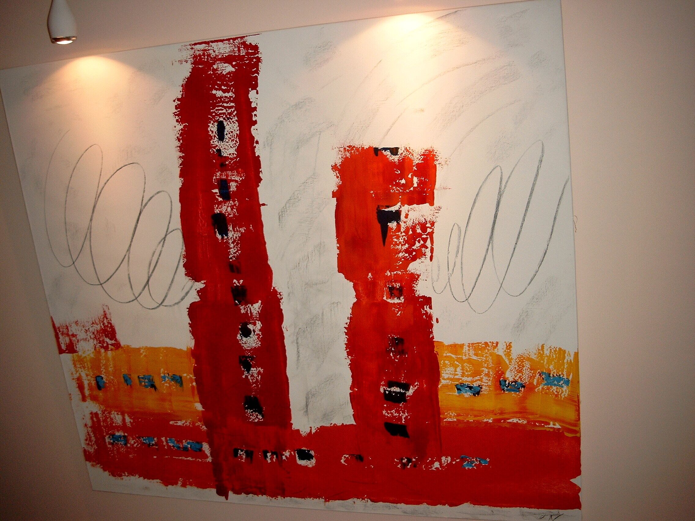 A large abstract painting with red, white, and black colors on a plain wall.