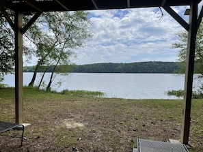 A gazebo with a view of a lake and forest. - Summer Openings! Perfect spot on lake for fishing! Spacious home & backyard (Iuka)