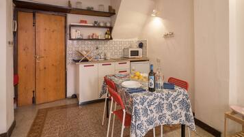 Economy Apartment, 2 Bedrooms, Partial Sea View | Private kitchenette | Full-size fridge, stovetop, coffee/tea maker, cookware/dishes/utensils