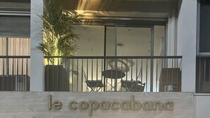 A hotel entrance with a sign reading "le copacabana". -  CHARMING APARTMENT ON THE BEAUTIFUL PROMENADE OF ENGLISH FACING THE SEA AND BEACHES (Nice)