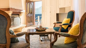 A cozy room with a fireplace, a comfortable chair with a cushion, and a view of the sea through a door. - Do you want to dream and relax? Welcome to the Morvan (Cussy-en-Morvan)