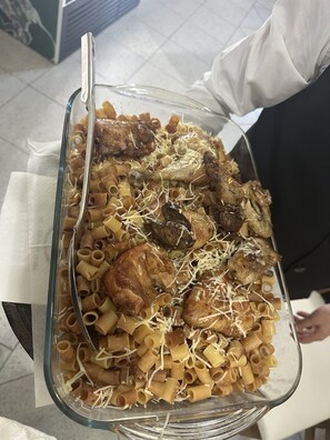 A glass dish filled with pasta, meat, and cheese. - ALBON Park (Berat)