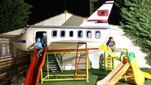 A children's play area with slides and climbing structures. - ALBON Park (Berat)