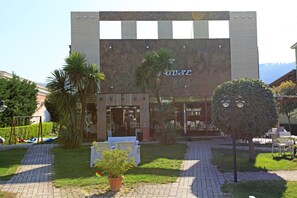 A modern building with a large sign reading "House". - ALBON Park (Berat)