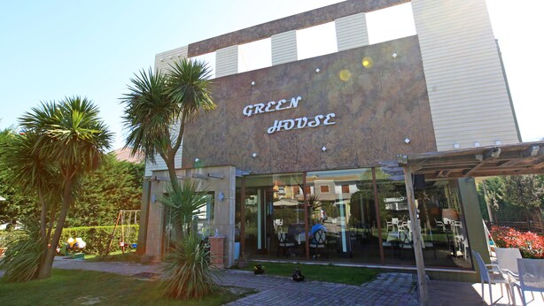 A modern building with a sign reading "GREEN HOUSE." - ALBON Park (Berat)