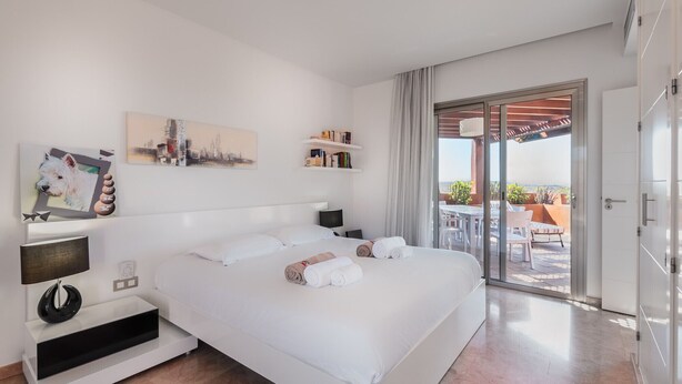 A hotel room with a bed, bedside table, and a view of the outdoor terrace. - Bahia - Alzaro 1.3 DELUXE SEA VIEW & JACUZZI 3B (Arona)