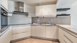 A modern kitchen with a built-in oven, stainless steel range hood, and a double sink. - Bahia - Alzaro 1.3 DELUXE SEA VIEW & JACUZZI 3B (Arona)