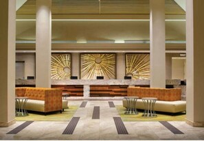 Welcome to our hotel lobby, featuring a central reception desk and comfortable seating areas.