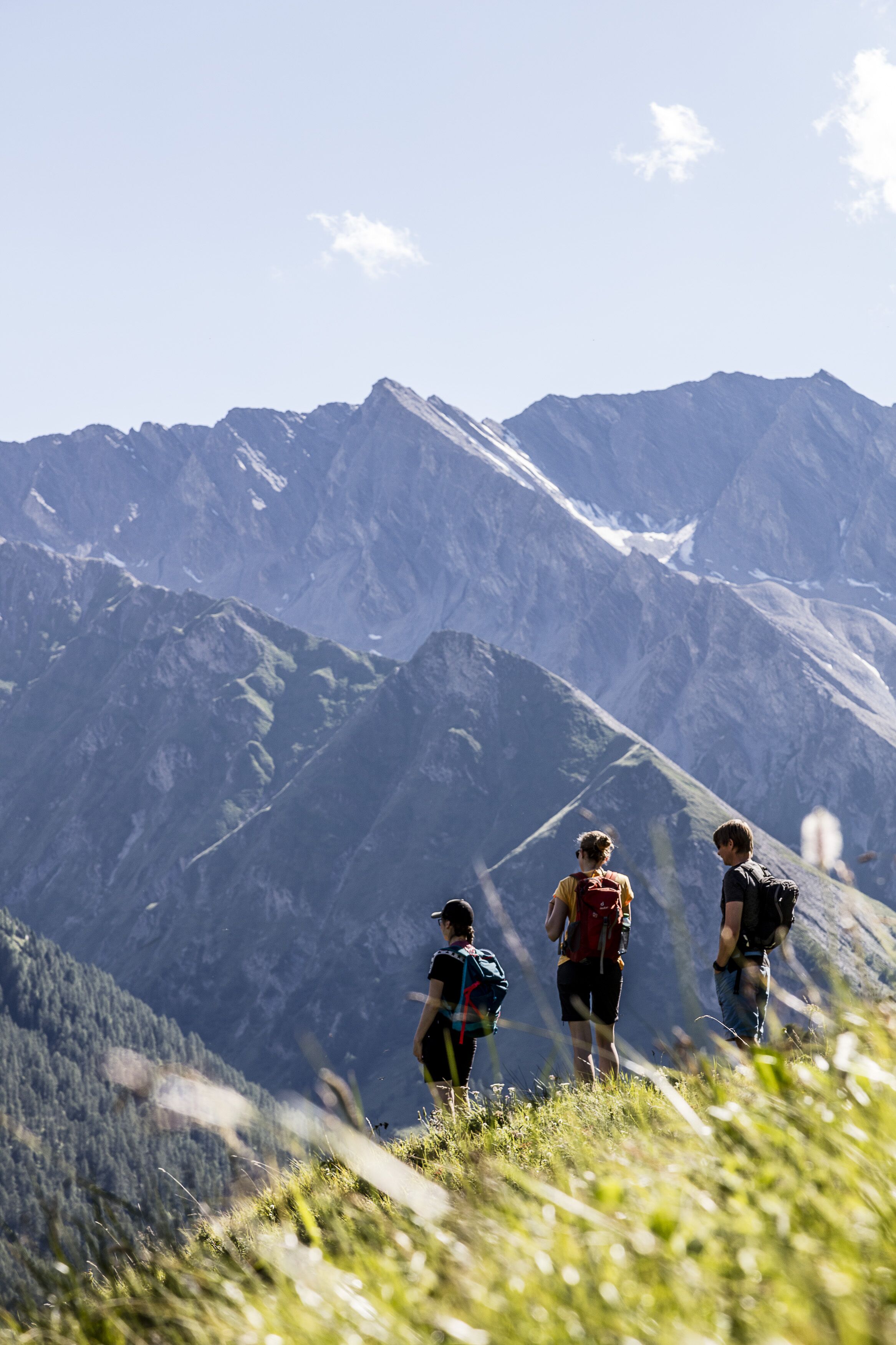 A mountain landscape with hikers.
