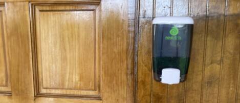 Una puerta de madera con dispensador de gel antibacterial.