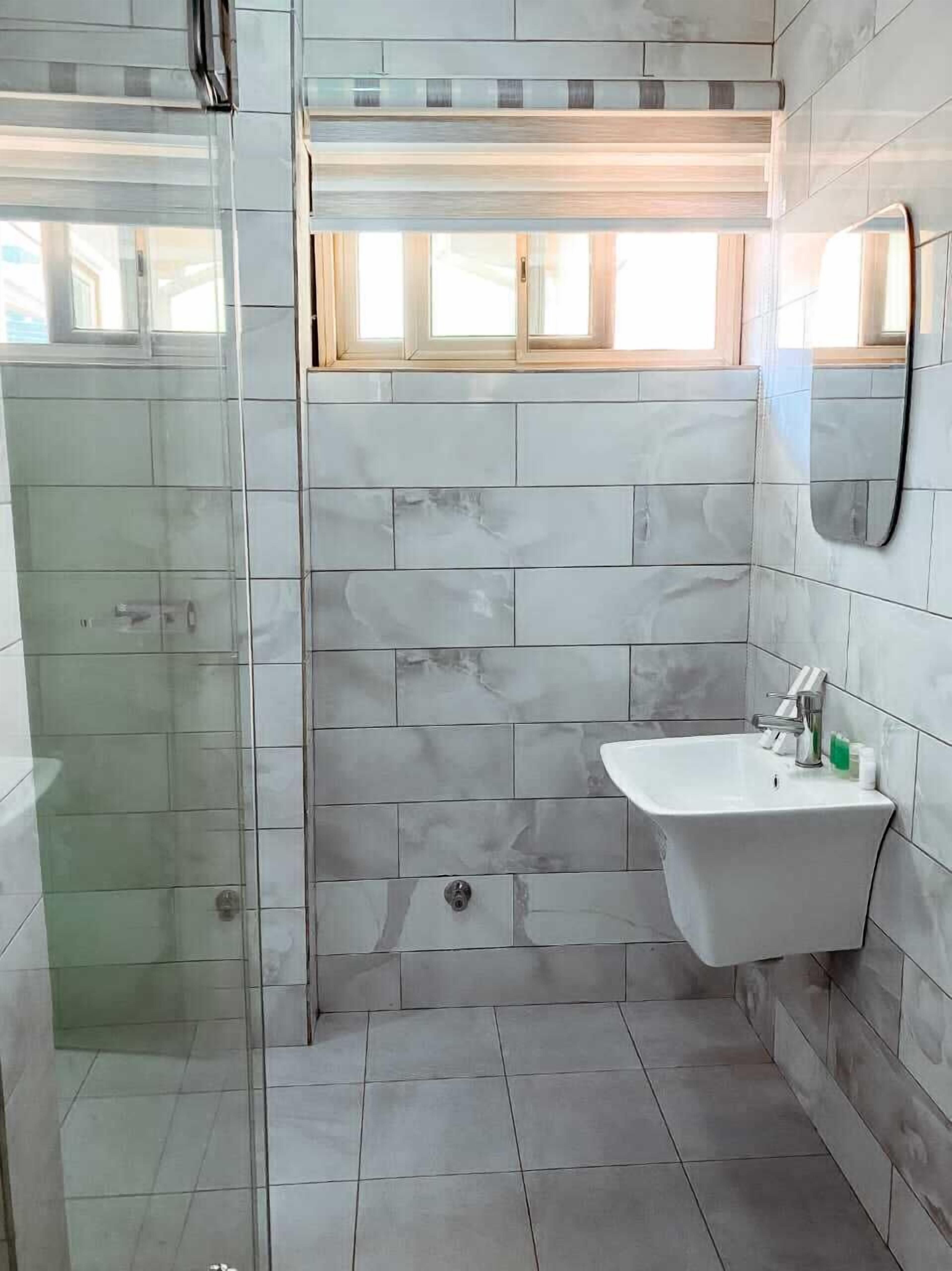 double or twin room | bathroom | shower, rainfall showerhead, free toiletries, towels