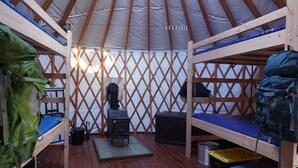 A yurt with two bunk beds, a stove, and storage bins. - Snowshoe or ski and relax by a warm wood stove while playing games! (Scofield)