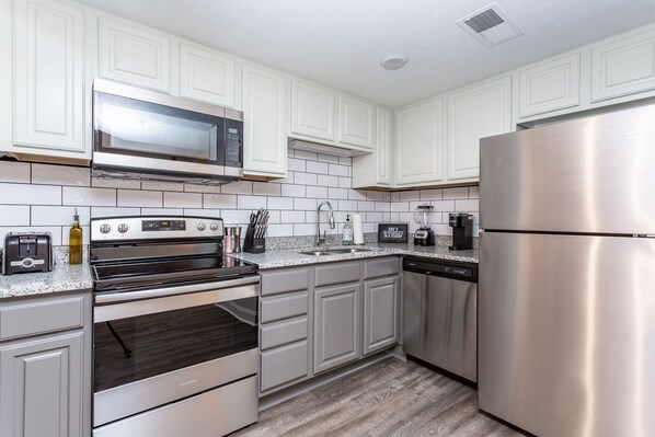 Microwave, dishwasher, coffee/tea maker, cookware/dishes/utensils