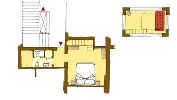 Un plan d’étage d’une chambre d’hôtel comprenant un lit, un bureau, une chaise, une petite table et une fenêtre.