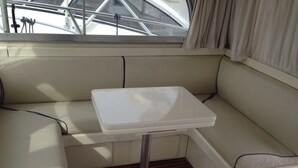 Un petit espace aménagé avec des sièges et une table, l’ensemble étant agrémenté de coussins.