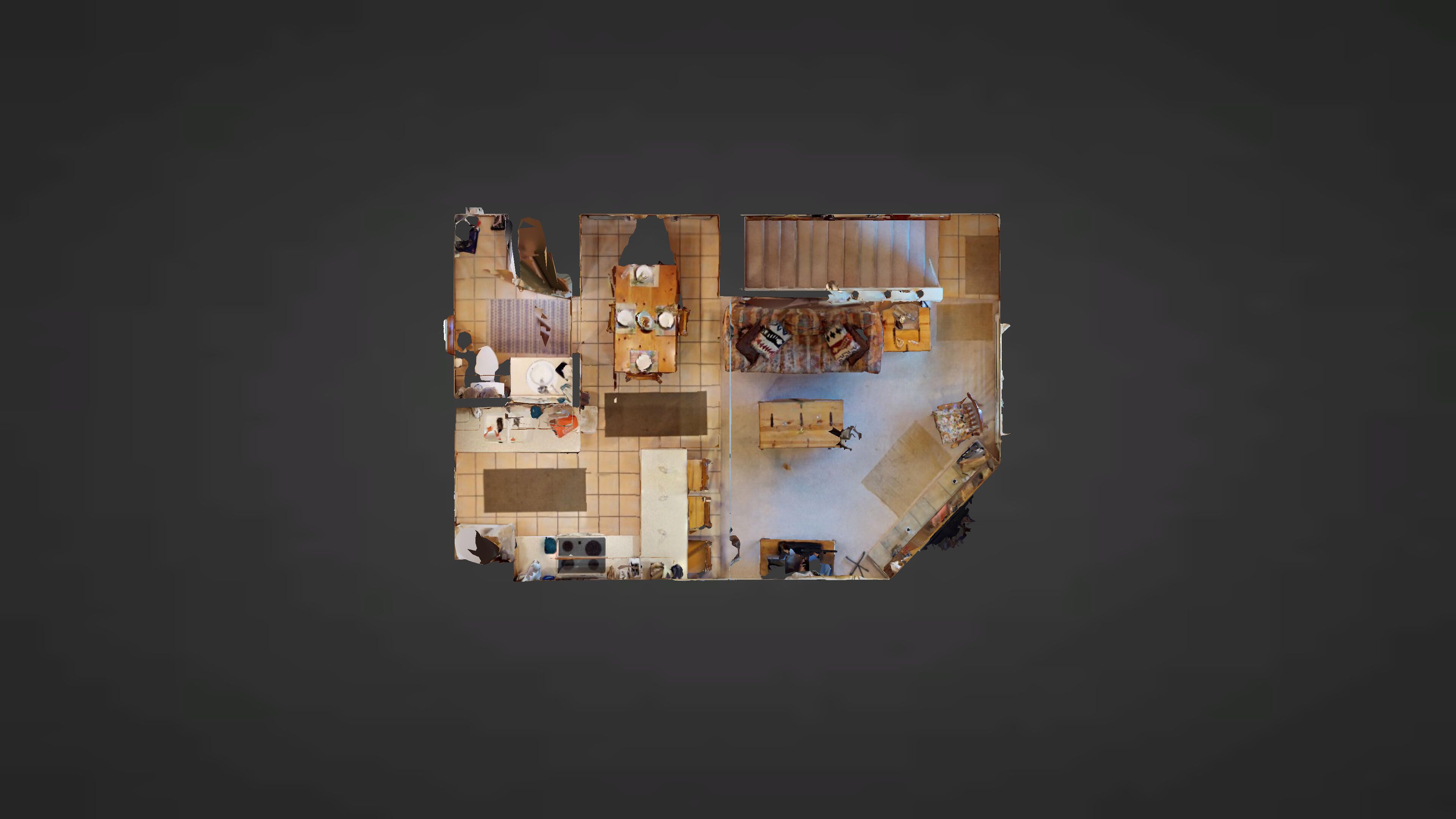 A room with a large bed, a desk, and a chair. There is a window and a door.