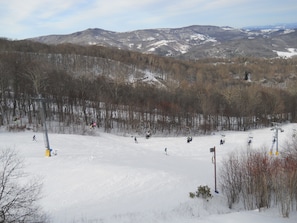 A ski slope with a chairlift and skiers. - Sugar Ski Comfort Two Bedroom - Unit 832 (Sugar Mountain)
