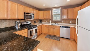 A modern kitchen with wooden cabinets, a stainless steel stove, a microwave, and a dishwasher. - Lakeside Home w/Views Near Basalt, 18 Mi. to Aspen (Basalt)