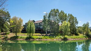 A large house with a deck, surrounded by trees and a lake. - Lakeside Home w/Views Near Basalt, 18 Mi. to Aspen (Basalt)