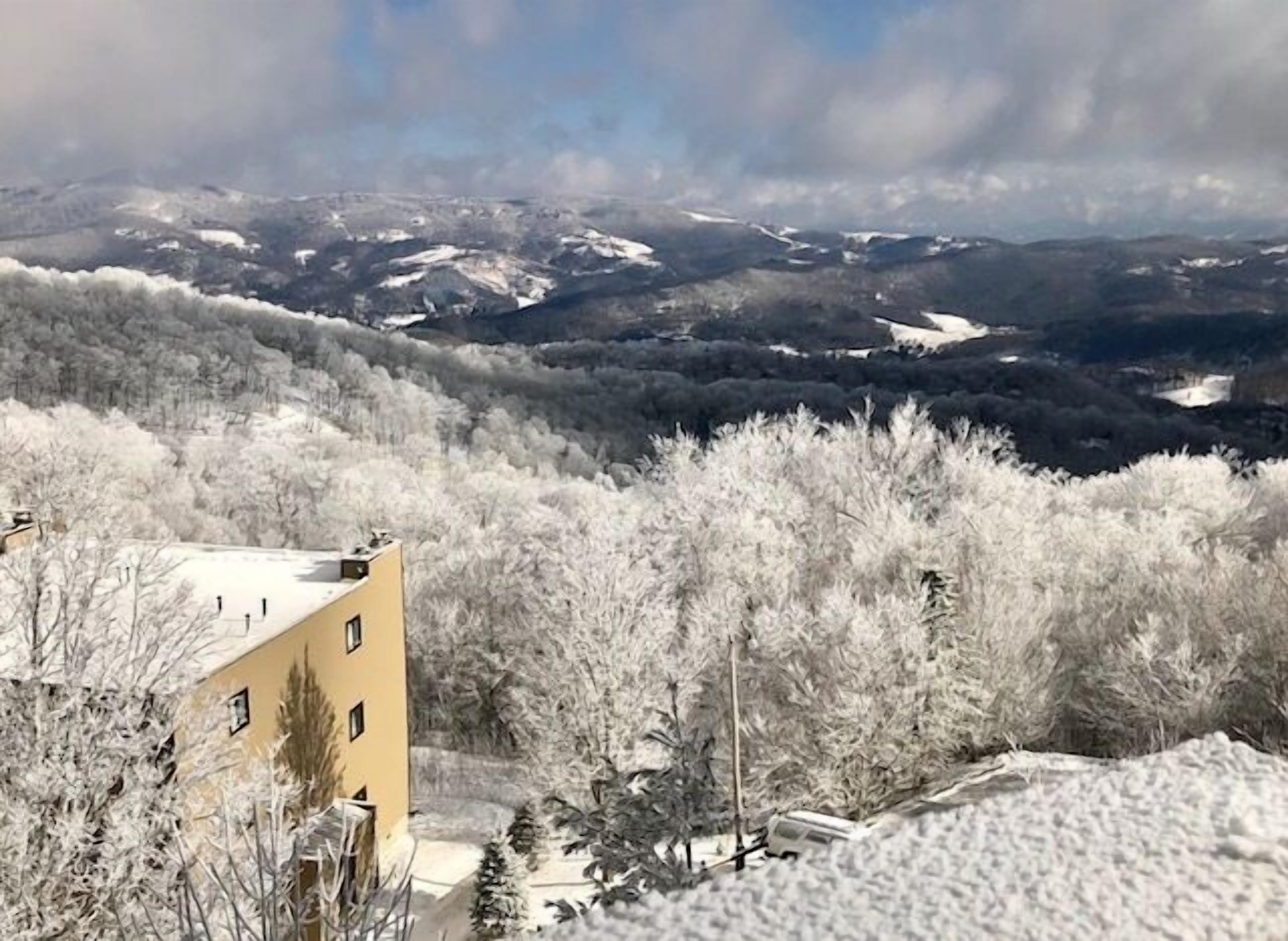 A building with a snow-covered landscape in the background.