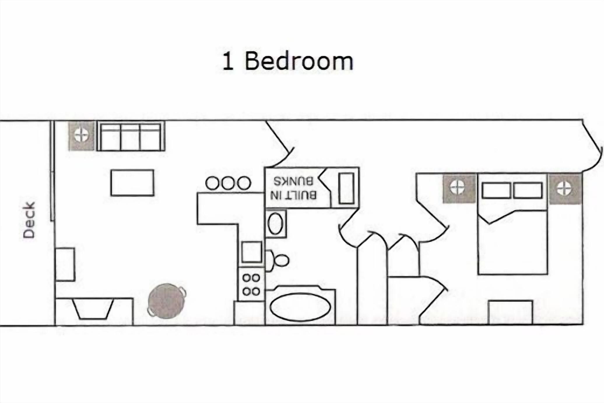Un appartement comprenant une chambre, une cuisine, une salle de bain, un petit coin salon et une terrasse.