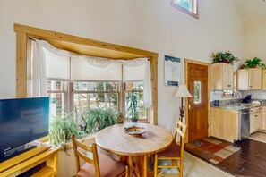 Relax in this inviting room with a dining table, flat-screen TV, and large windows.