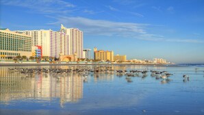 A beachfront hotel with multiple high-rise buildings, a sandy beach, and a large body of water. - 1 Bd Condo, Wide Open Ocean F U N! Atlantic_1BD (Daytona Beach)