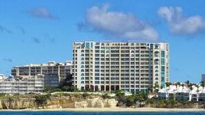 A multi-story hotel with balconies, located near a beach. - The CLIFF - 4th-floor Luxury Condo on the Beach - Luxury Beachfront Resort  (Cupecoy)