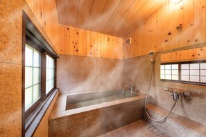 A modern bathroom with a stone bathtub, wooden walls, and a window. - SenzanAn Kitamachi 101 (Yuasa)
