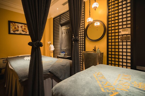 A hotel room with two beds, a mirror, a sink, and a wall-mounted heater. - Solaria Hotel (Hanoi)