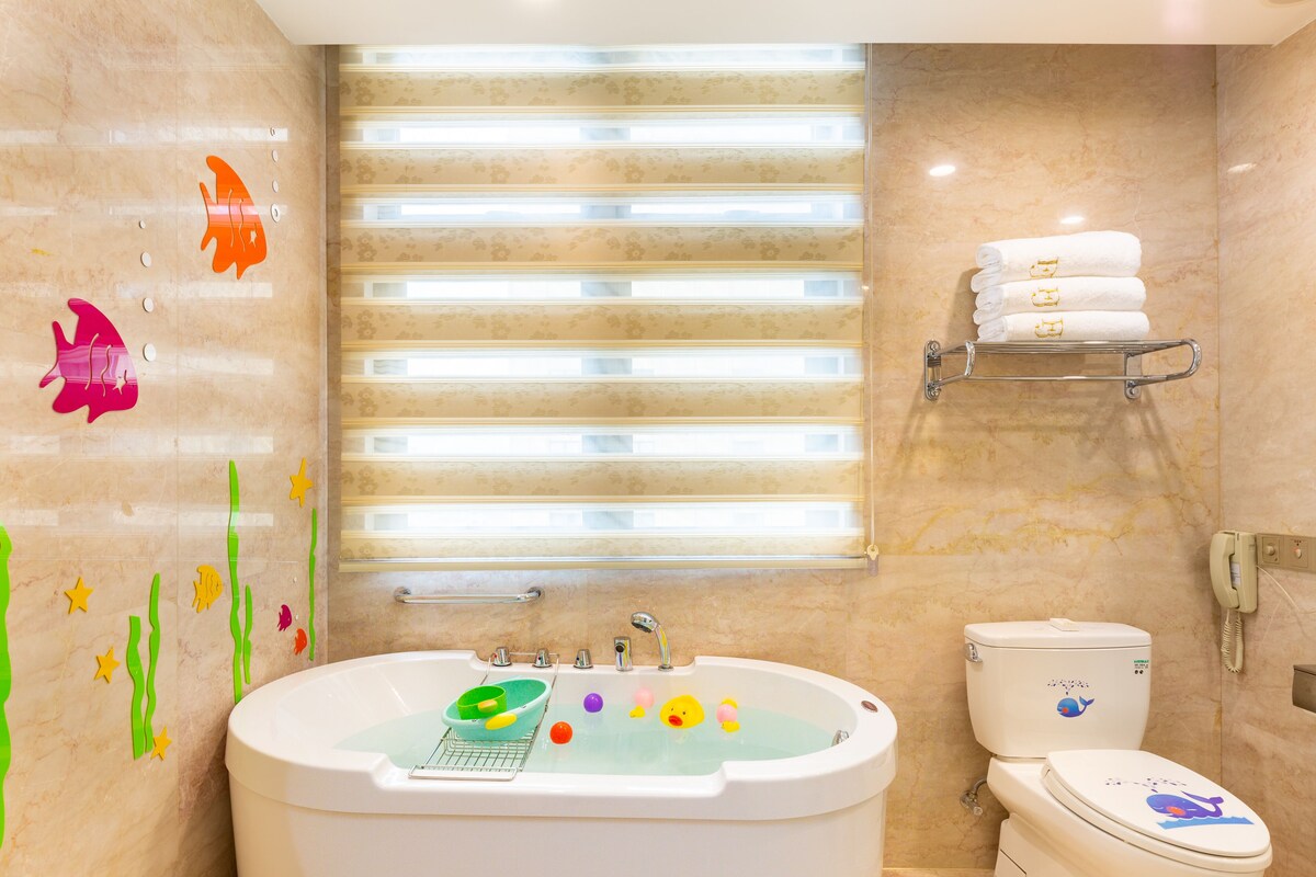 Bathtub, hair dryer, bathrobes, slippers