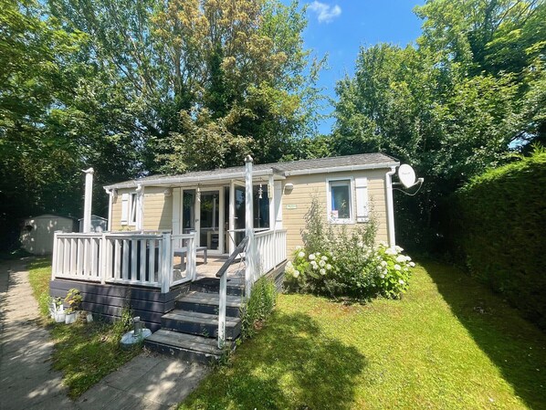A small, single-story house with a porch and a small garden.