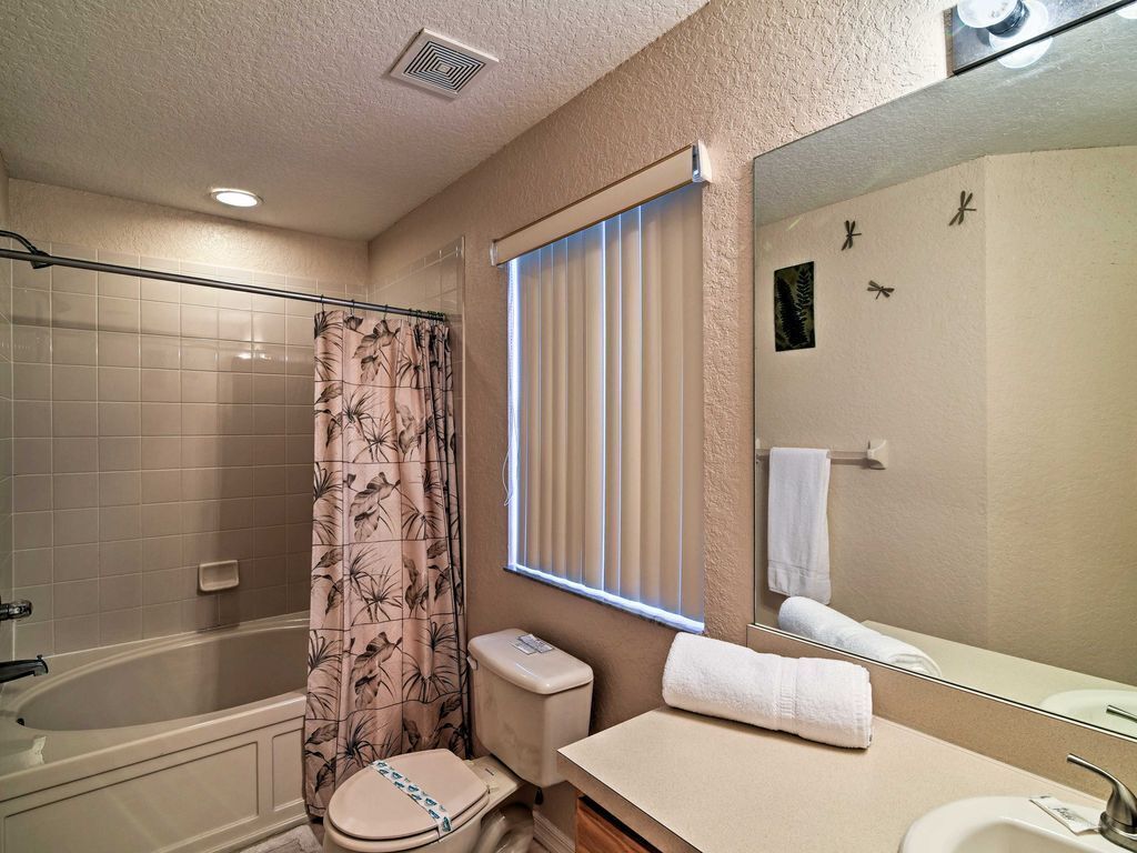 A bathroom with a bathtub, toilet, and sink.