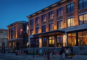 A hotel with a brick facade, large windows, and a covered entrance area. - Hammetts Hotel (Newport)