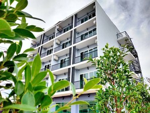 A multi-story building with balconies, air conditioning units, and a modern architectural design. - The Beach at Klong Muang (Krabi)