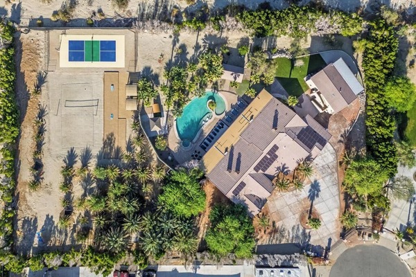 Zoom out and feast your eyes on the ultimate backyard glow-up — a desert resort-style playground carved right into the palms.