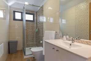 Shower, hair dryer, towels, toilet paper