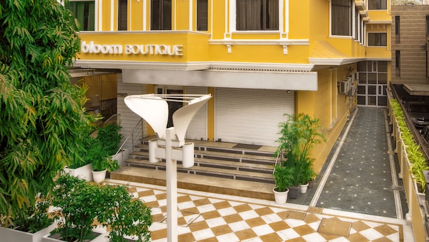 A yellow building with a checkered floor and a sign that reads "BLOOM BOUTIQUE". - Bloom Boutique Gk-1 (New Delhi)