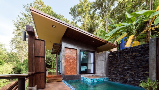 A modern house with a pool, wooden deck, and a stone wall. - Chiang Mai Elephant Friends (Mae Wang)